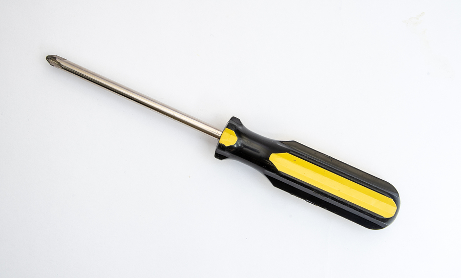 Black and yellow handled philips screwdriver on a white background